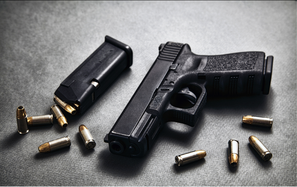 Pistol and ammunition arranged on a neutral surface