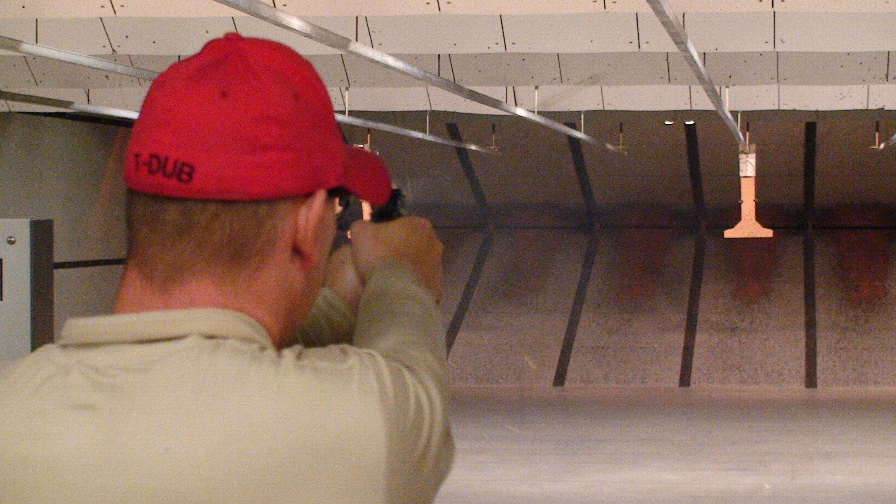 Firearms practice with a paper target at an indoor range